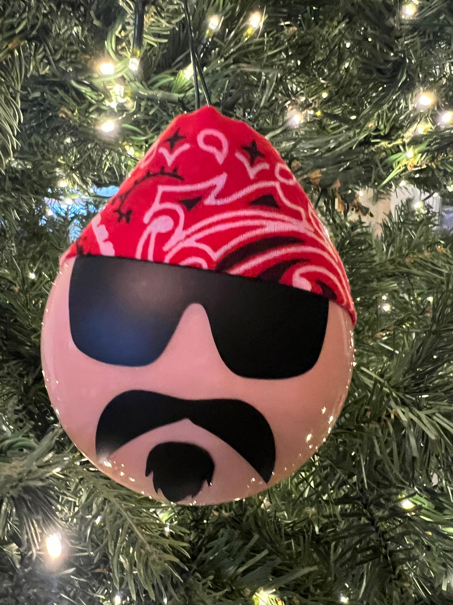 Decorative head with red bandana and black design on a Christmas tree