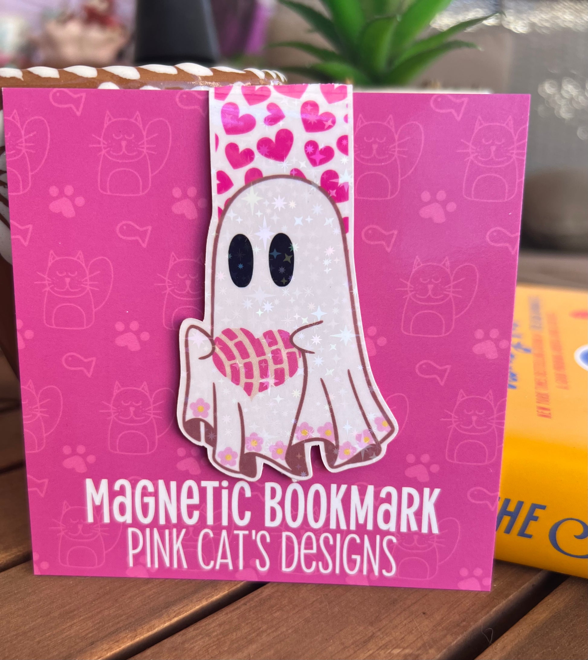 Pink magnetic bookmark with ghost design and 'Pink Cat's Designs' branding on a pink background.