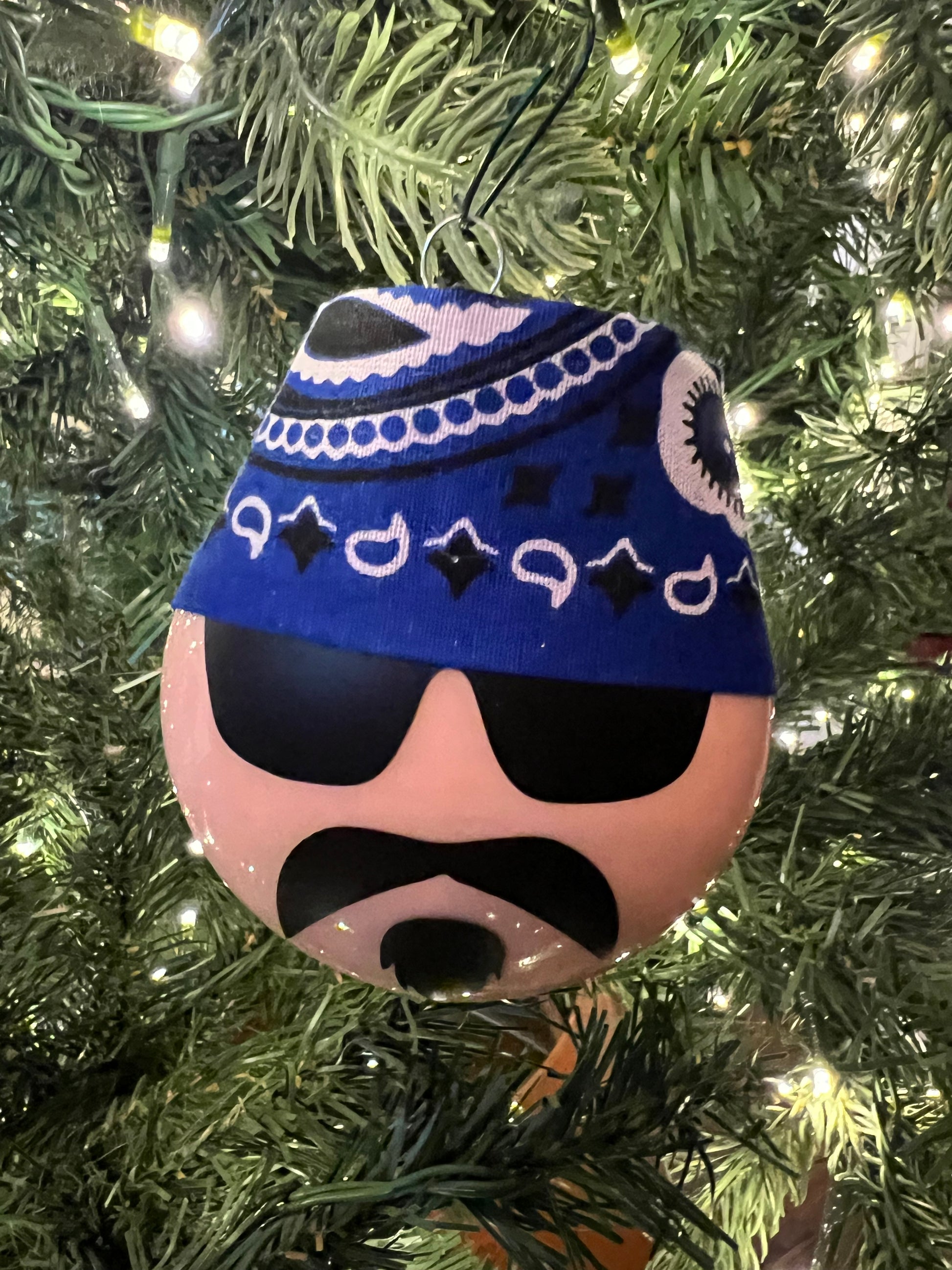 Decorative ornament with a blue and white pattern on a Christmas tree.