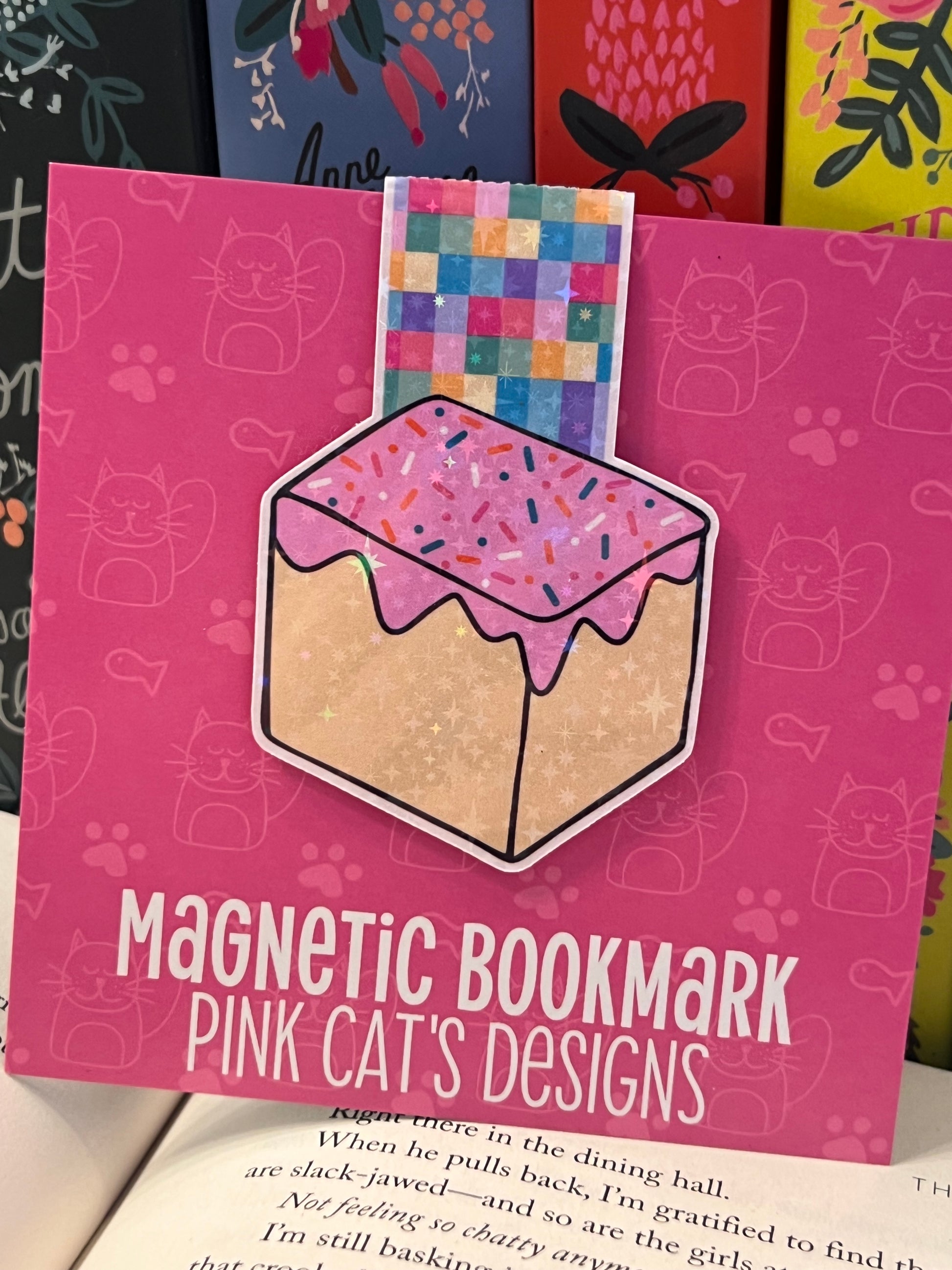 Pink magnetic bookmark with a colorful design on a pink card with text
